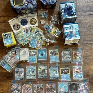 Pokemon Card Collection with Tins and Accessories 25 card Mystery Tin plus bonus